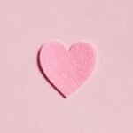 Home A simple pink felt heart on a light pink background, perfect for Valentine